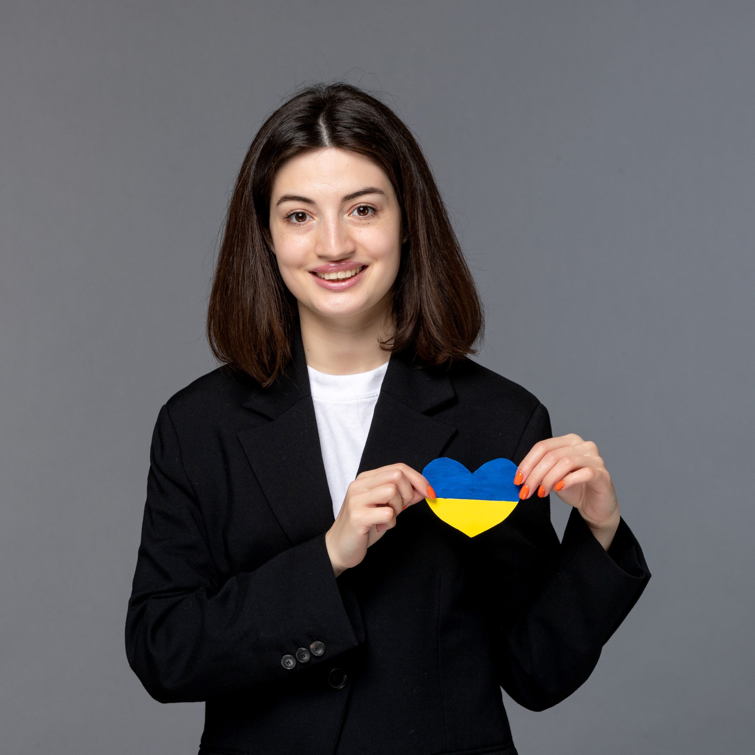 ukraine russian conflict cute young dark hair woman in black blazer brave with heart